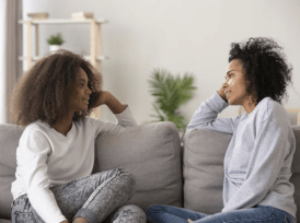 Parent and child talking on the sofa about abortion